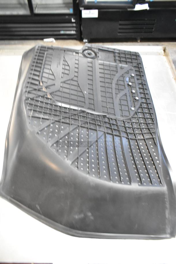 Brand new scratch and dent black floor mat, durable design with patterned grip, part of Camaro cover auction set.