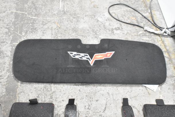 Black car floor mat with Corvette logo, part of a tiered auction lot. Appears to be in good condition.