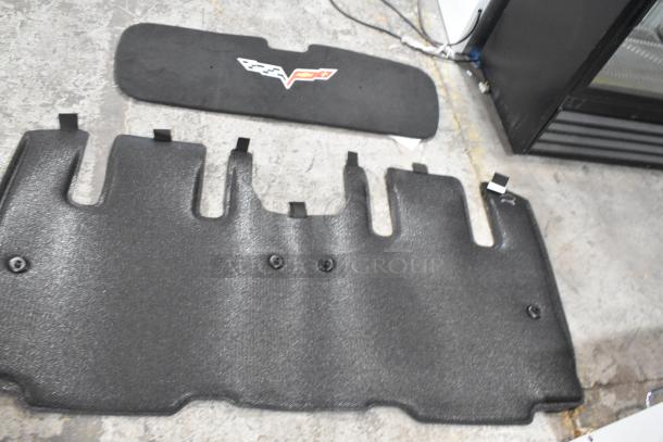 Tier lot of various items, featuring black car floor mats with logo. Items appear in used condition.