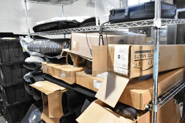 Auction tier lot with various items including car floor mats, boxes, and accessories on metal shelves, in good condition.