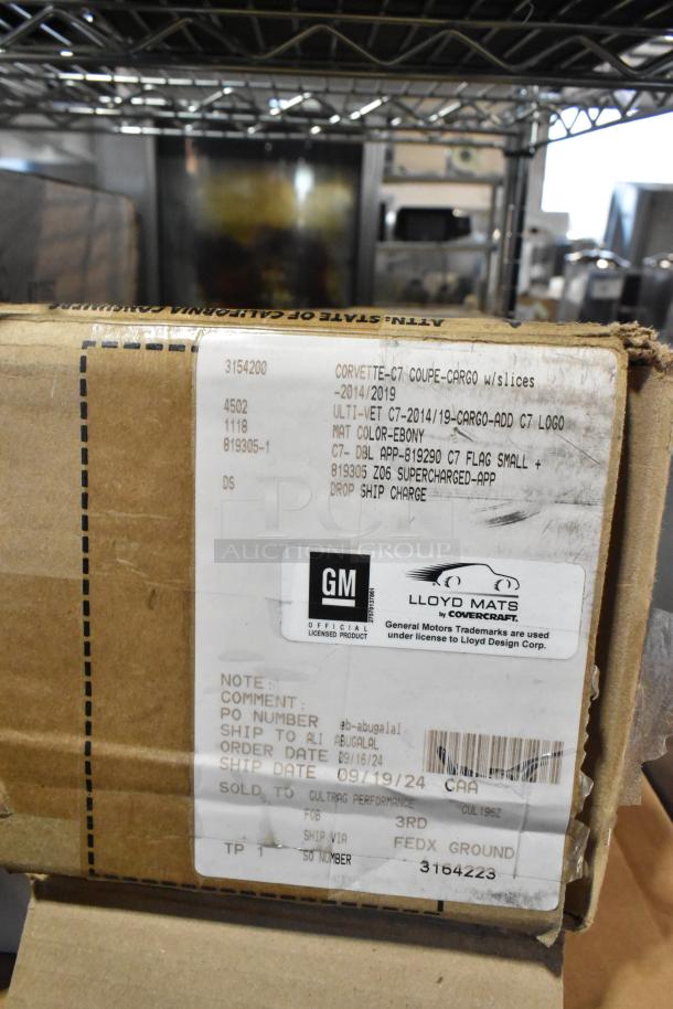 Box labeled for Corvette C7 Coupe cargo floor mats, 2014-2019, ebony color, GM licensed, by Lloyd Mats.