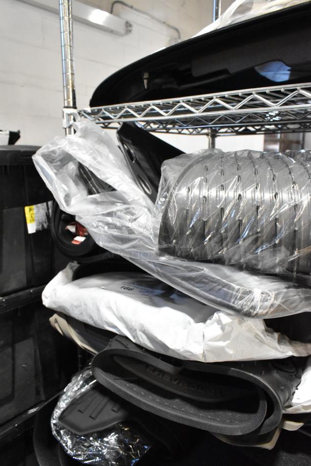 Tiered lot of various items, including black car floor mats labeled "Chevrolet," in mixed packaging.