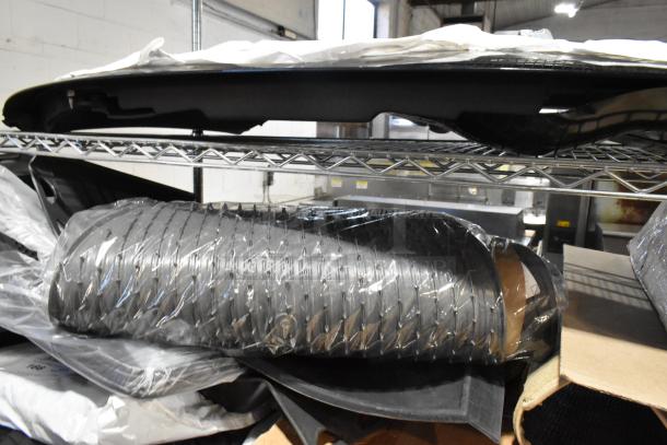 Tier lot of various items, including car floor mats in plastic wrapping on a metal shelf. Condition appears new.