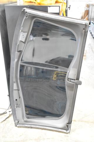 Car panel with clear glass, grey frame, and black handle. Slight wear visible on edges.