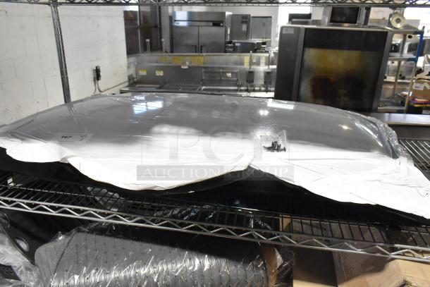 New car panel wrapped in protective packaging on a metal shelf. Includes mounting screws. Labels indicate item is unused.