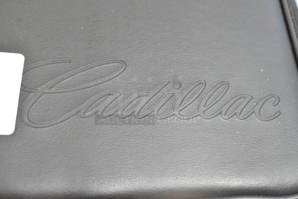 Black leather Cadillac kit case, embossed logo, pristine condition, ideal for collectors or Cadillac owners.