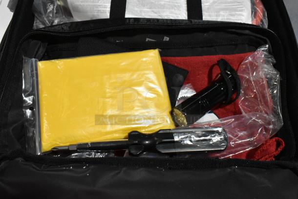 Cadillac Kit with tools in a black case, includes yellow bag, flashlight, screwdriver; for automotive use.