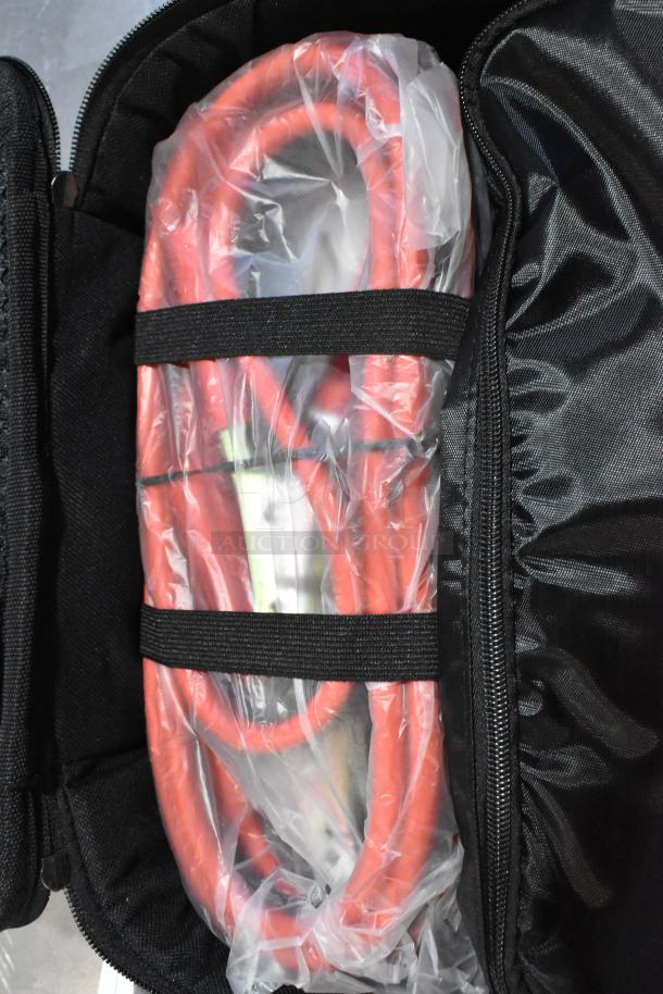 Cadillac Kit in a black case, featuring red cables secured with straps, in new condition with protective wrap.