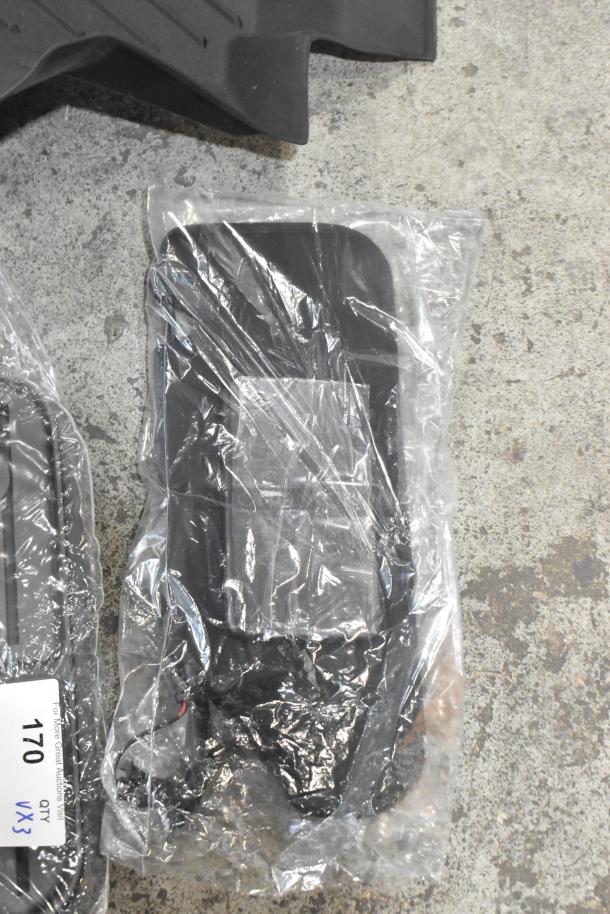 Three various items including a black car floor mat in new condition. Includes quantity label: "QTY VX3, 170." Plastic packaging visible.