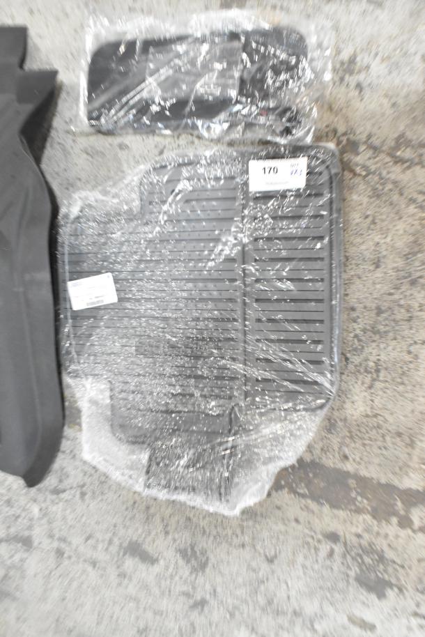 Three various items including a wrapped car floor mat. Visible label shows auction number 170. Items appear new.