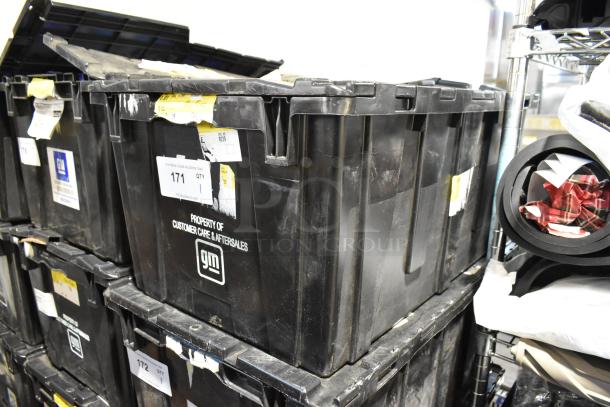Black poly bin containing ACDelco Versatrak Fluid and black floor mats. GM label indicates "Property of Customer Care & Aftersales."