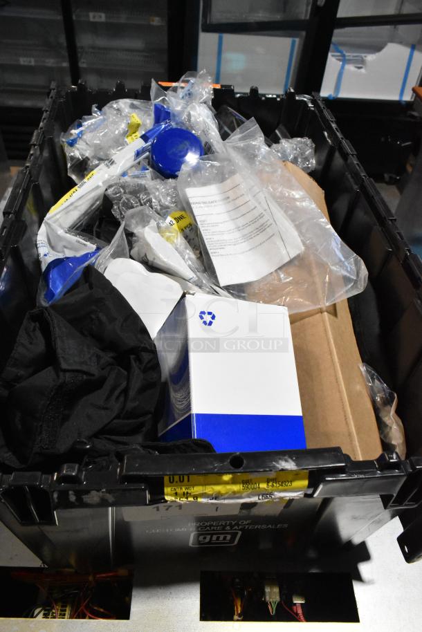 Lot of various items including ACDelco Versatrak Fluid and black floor mats in a black poly bin. Mixed condition.