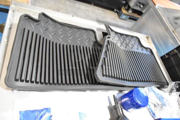Lot featuring black floor mats, ACDelco Versatrak Fluid in poly bin. Good condition, ideal for diverse utility needs.