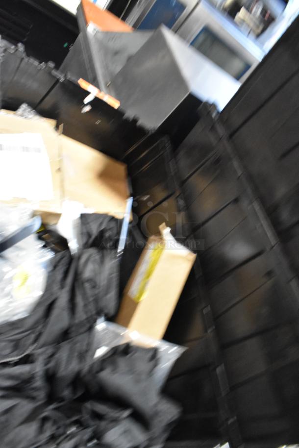 Lot of unspecified items in a black poly bin, includes ACDelco Versatrak Fluid and black floor mats. Condition varies.
