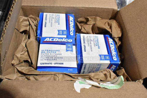 ACDelco Ultraguard oil filters in boxes, model UPF48R, in packaging. Part of mixed lot in black poly bin.