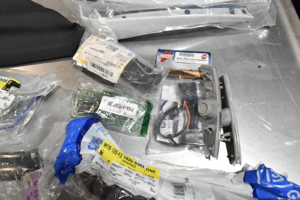 Lot of various items, including ACDelco Ultraguard Oil Fluid, in a black poly bin. Items include packaged car parts with visible labels and markings.