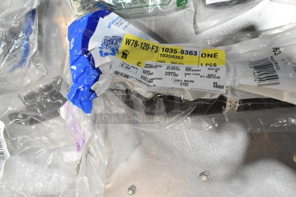 Lot of various items including ACDelco Ultraguard oil fluid in a black poly bin, tags show part number and specs.