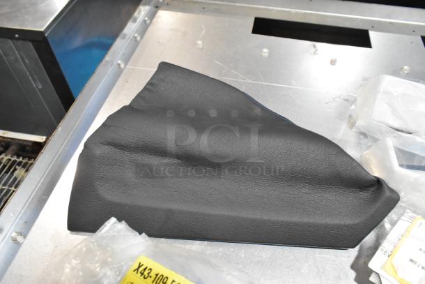 Black poly bin containing a lot of various items, including ACDelco Ultraguard oil fluid. Features a textured surface.