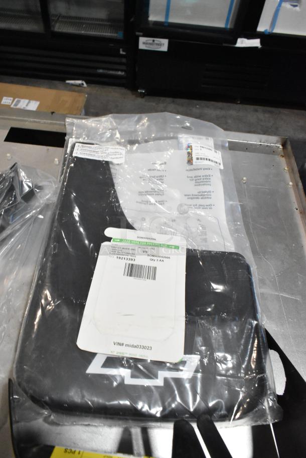 Lot of various items in black poly bin, including a cargo net. Visible labels detail part numbers and VIN.