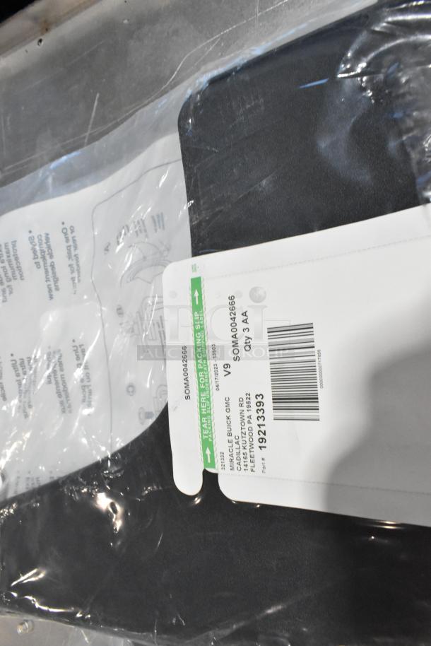 Lot of various items including a cargo net in a black poly bin with visible label showing part number 1921393 and warehouse details.