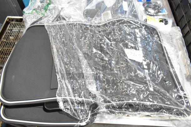 Lot with black mats and oil filter in black poly bin, wrapped in clear plastic, various items included.