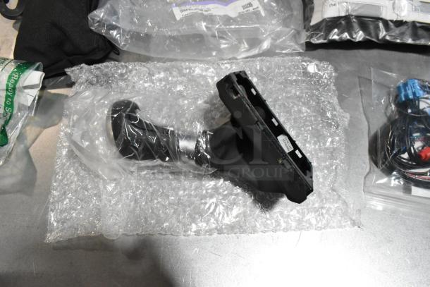 Lot of various items in poly bin; includes GM wheel locks and black stick shift in packaging.