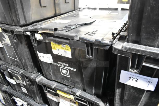 Black poly bin containing various items, including floor mats. Labels indicate "Property of Customer Care & Aftersales."