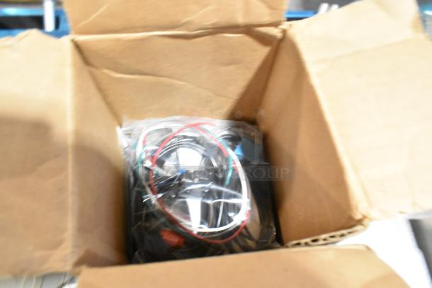 Box containing assorted items and cables in a poly bag. Part of a lot with floor mats in a black poly bin.