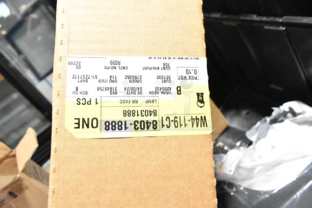 Lot of miscellaneous items in a black poly bin, includes floor mats. Visible box label: W44-19-CI, item order details.