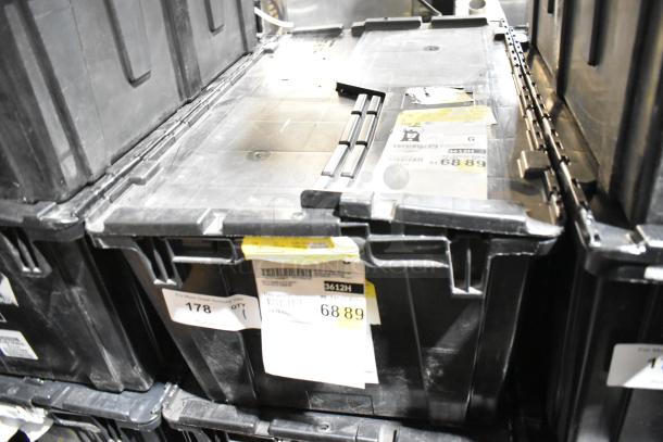 Black poly bin with various items, including dog toys. Visible labels with numbers 3612H, 68 89, indicating inventory details.
