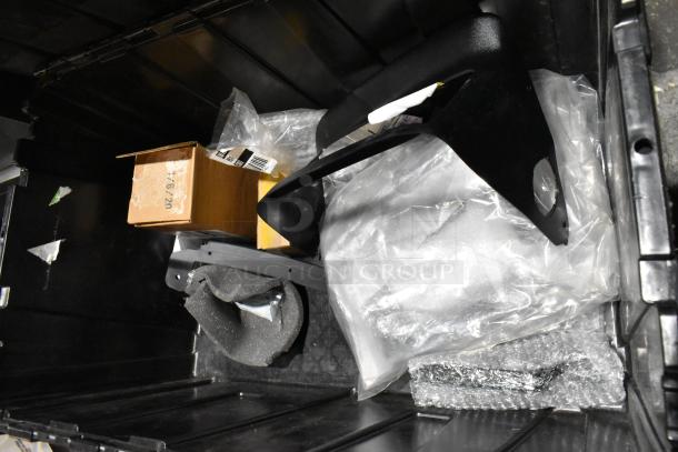 Lot of various items including black mud flaps, in a black poly bin. Includes boxes and packing materials.
