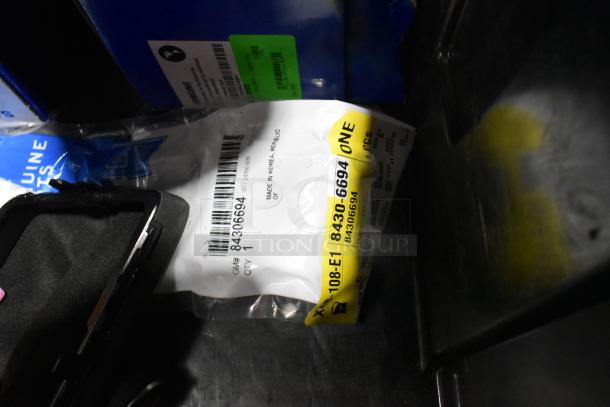 Lot of various items in a black poly bin, featuring Samsung C504S ink cartridges. Packaging shows labels with product info.