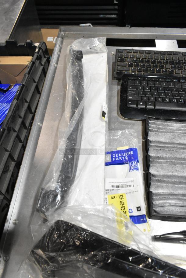 Lot including ZP505 label printer, keyboards, GM parts, and accessories in a black poly bin. Mixed condition.