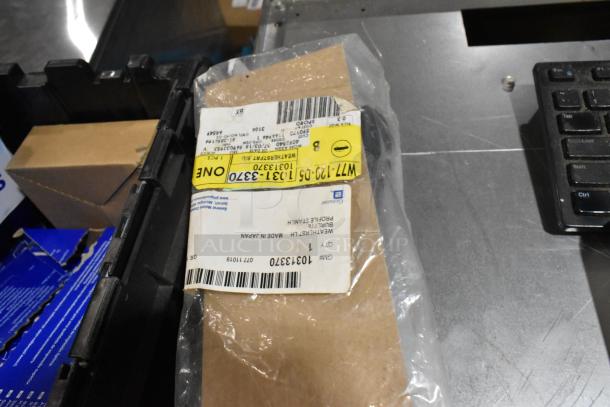 Lot of assorted items in a black poly bin, including a ZP505 label printer and keyboards. Label details shipment.