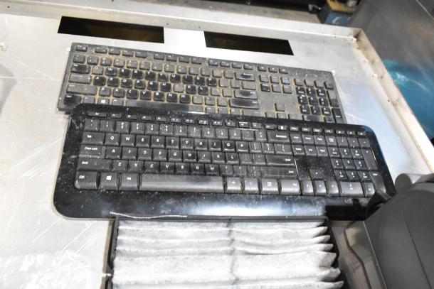 Lot of used electronics including ZP505 label printer and multiple keyboards, housed in a black poly bin. Mixed condition.