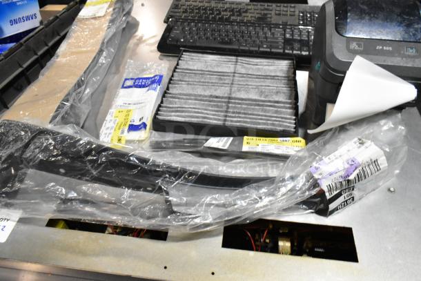 Lot with ZP505 label printer, keyboards, air filter, various items in black poly bin. Items mixed, visible labels included.