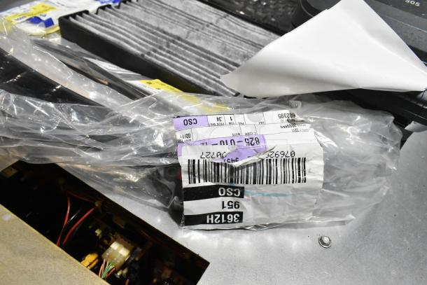 Lot includes various items such as ZP505 label printer and keyboards in a black poly bin. Item tags visible.