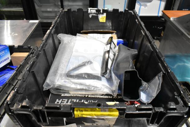 Black poly bin with various items including an air filter and license plate frame. Items appear mixed, condition unknown.