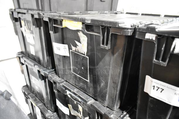 Black poly bin with various items including an air filter and license plate frame. Visible labels and markings on the bin.