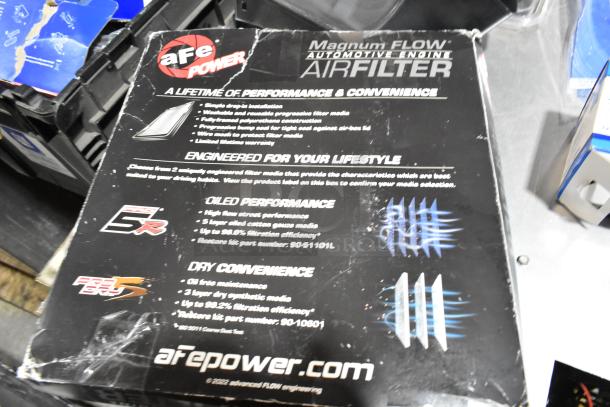 Lot with various items, including aFe Power Magnum FLOW automotive air filter in a black poly bin. Packaging shows features and part numbers: 31-10101L, 31-10081.