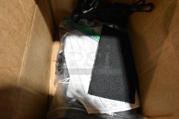 Lot of various items including headphones and tape in black poly bin, mixed condition, packaged in a cardboard box.