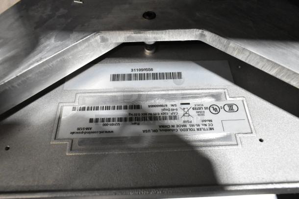 A silver metallic surface with various barcodes and labels featuring model and manufacturer information, including "Metl-Span."
