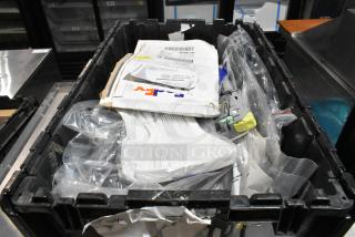 Black poly bin containing various items, including ACDelco Dexron LS gear oil and a Brother label printer.