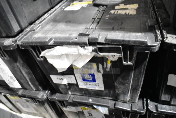 Black poly bin with visible labels, containing ACDelco Dexron LS gear oil and a Brother label printer. Bin shows wear.