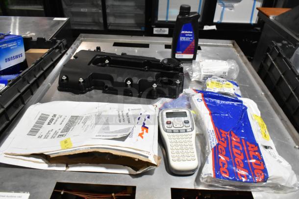 Lot with ACDelco Dexron LS Gear Oil, Brother label printer, and more in black poly bin; assorted items visible.