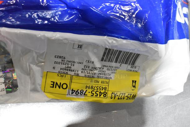 Lot of items in black poly bin, includes ACDelco Dexron LS gear oil and a Brother label printer. Packaging labels visible.