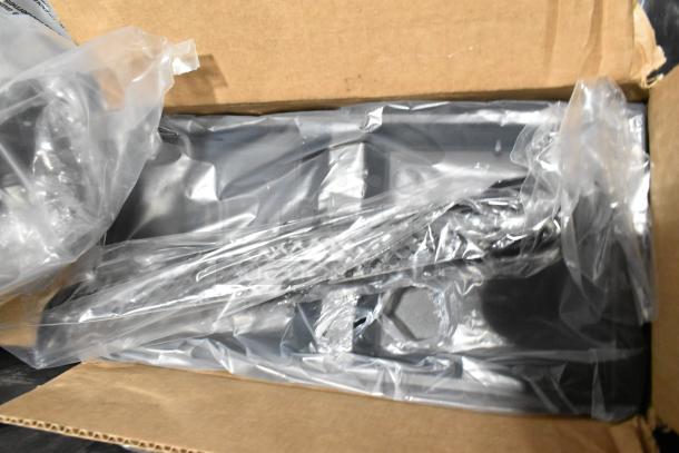 Lot with ACDelco Dexron LS Gear Oil and Brother Label Printer, packaged in black poly bin, shown partially unwrapped.