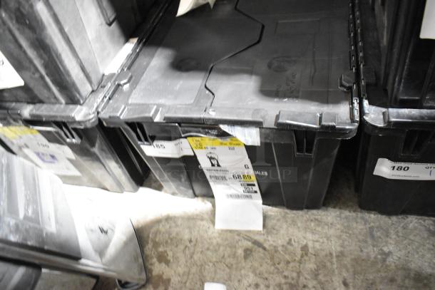 Black poly bin containing various items, including a corded telephone and thermometer. Visible labels show lot details.