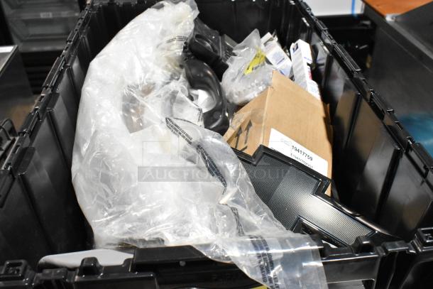 Lot of various items including corded telephone, thermometer, in black poly bin; visible packaging and box.