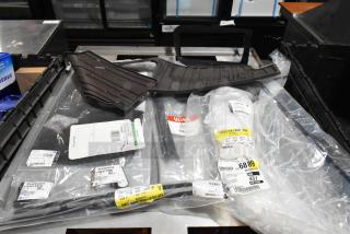 Lot of various items including floor mats and cable ties in black poly bin. Tags with item codes and "ULINE" branding visible.